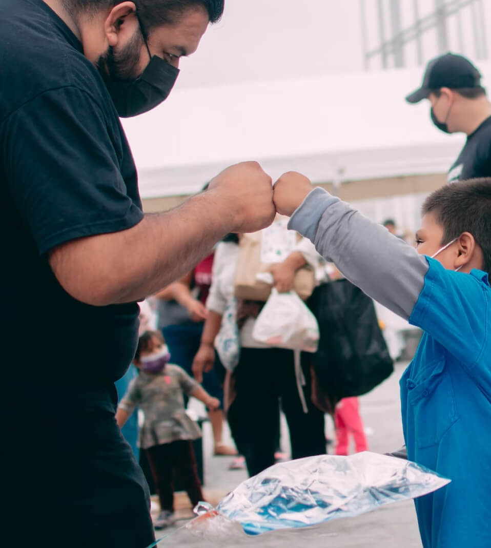 boy giving man fist bump